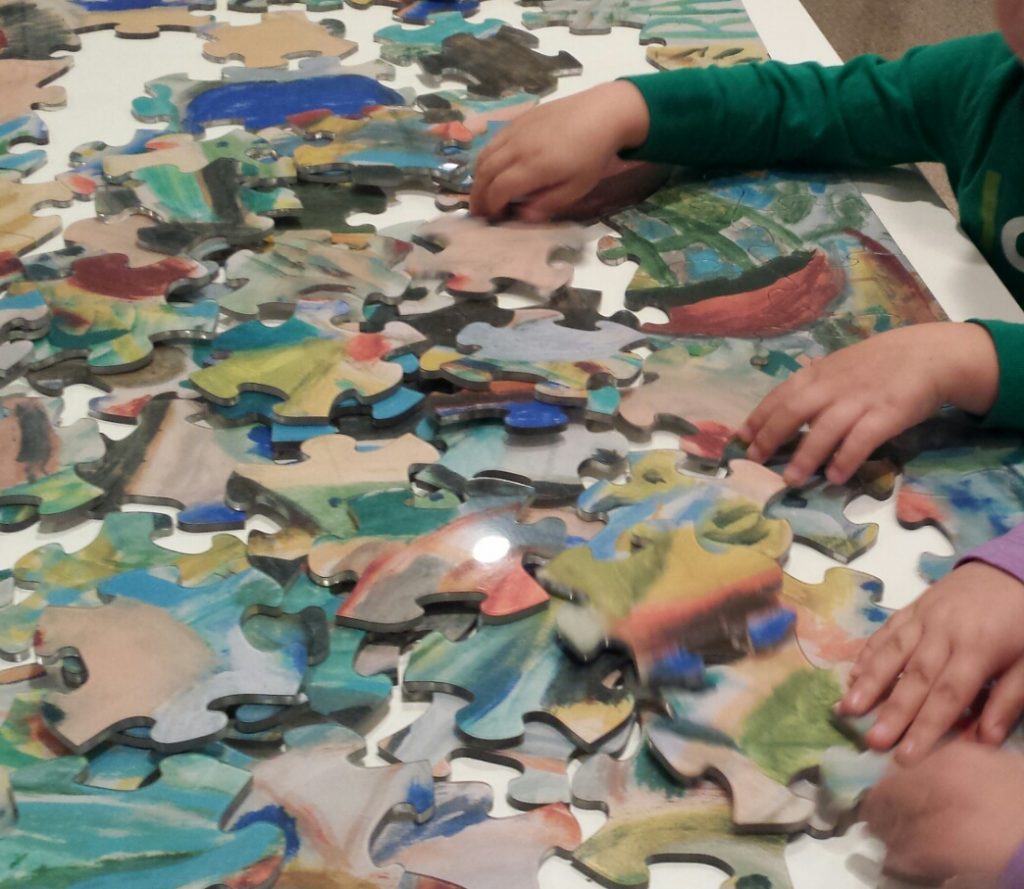 A puzzle of a painting, each piece is really colorful and the painting is unknown as the puzzle is still more pieces than a defined thing. Columbus Museum of Art kids safe fun!