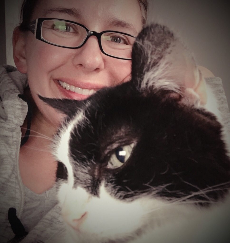 Saying goodbye to Draco. Pictured is a brown haired woman and a black and white cat. 