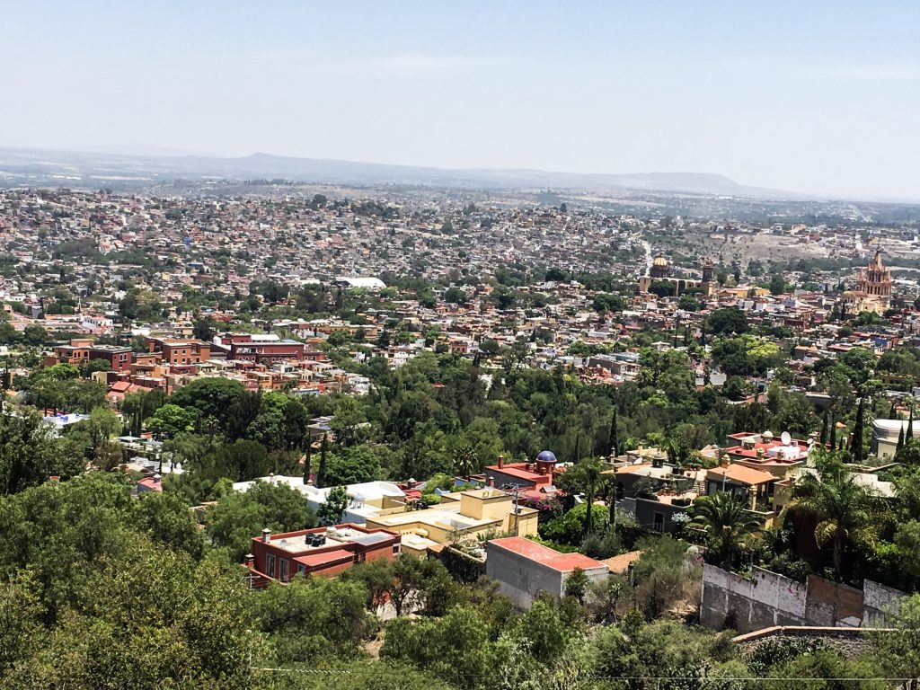 A view of San Miguel from a mountain overlook. The city spreads out below.