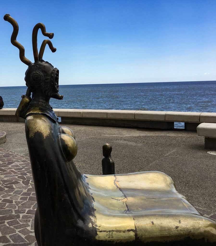 A unique bronze statue that doubles as a chair. The head is a cross between a deep diver and sea monster. 