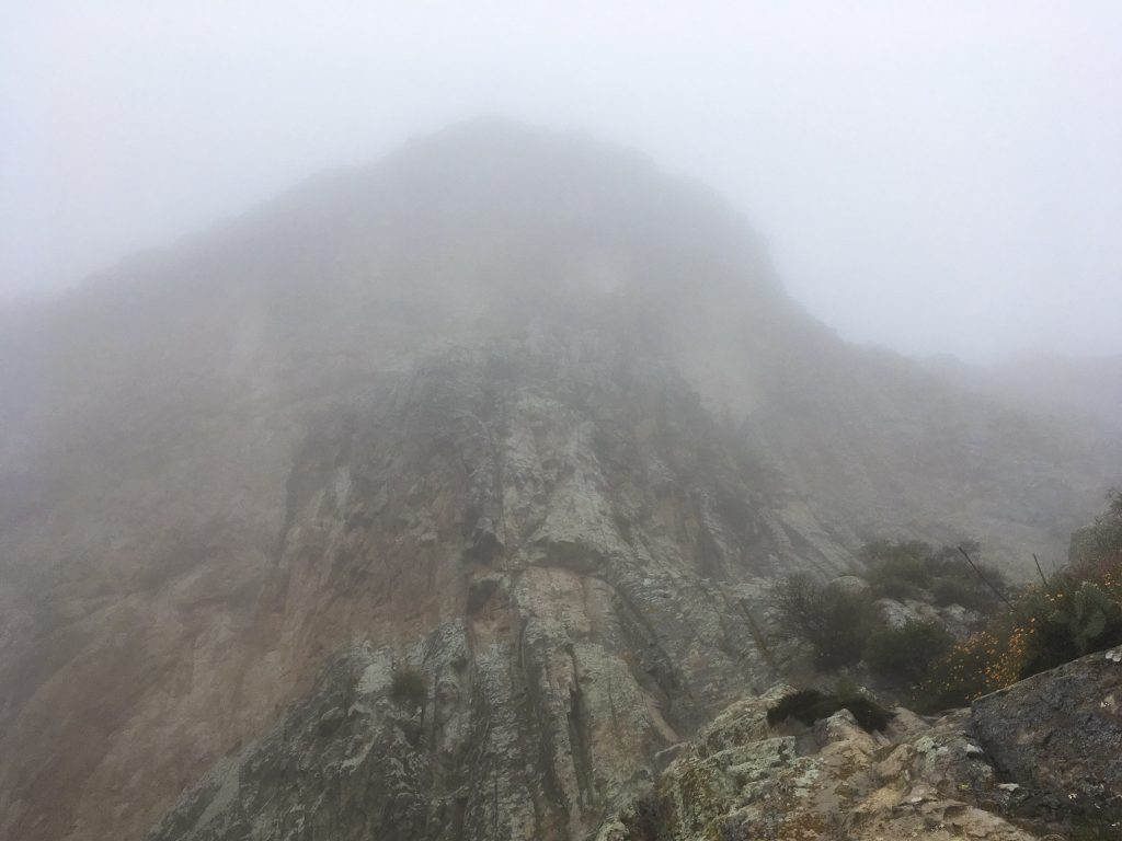 A Peña de Bernal shrouded in fog on a rainy Saturday.