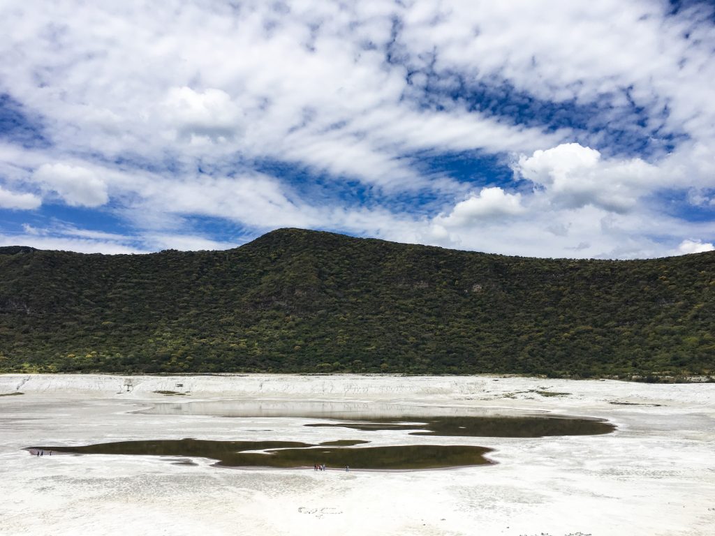 Las Siete Luminarias, a lush green mountain, with a white, barren crater. It looks like snow in the crater, but it isn't. It's kind of sandy clay. 