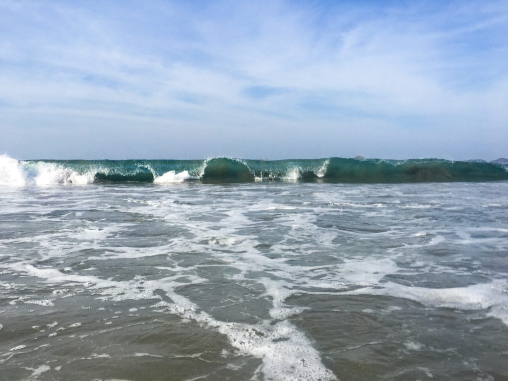 from the shore, watching a wave break on the Pacific Ocean