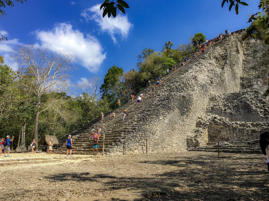 People climbing the pyramid at Coba.