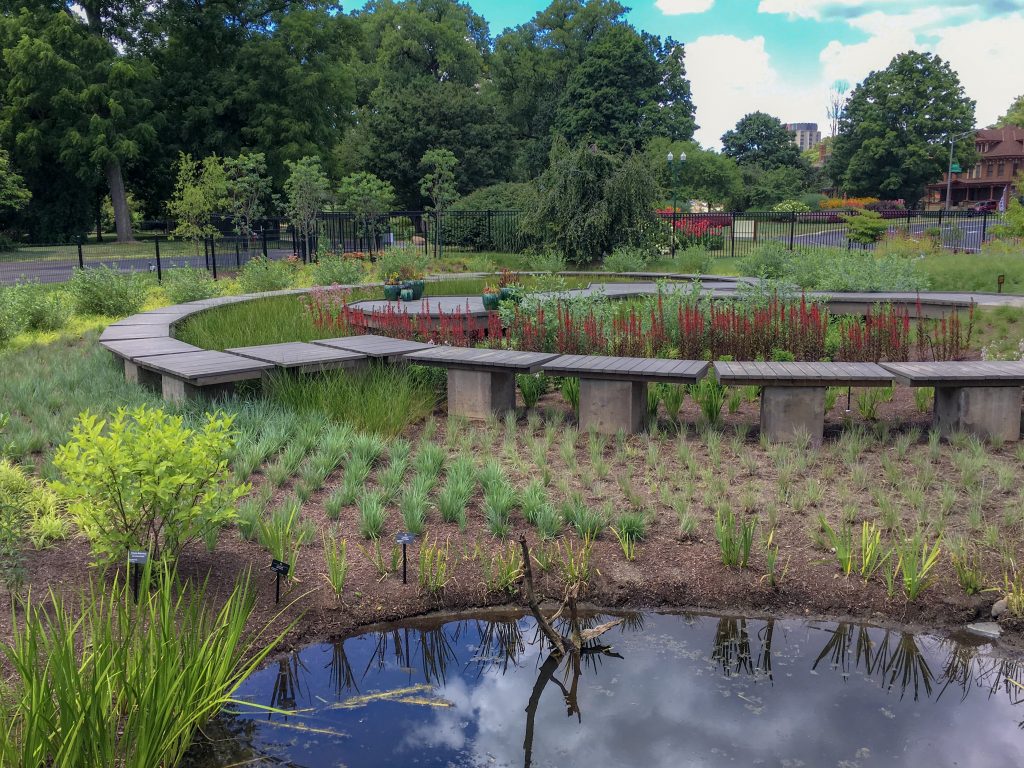 A small pond in the foreground and a wooden boardwalk in the background at Franklin Park Conservatory Children's Garden