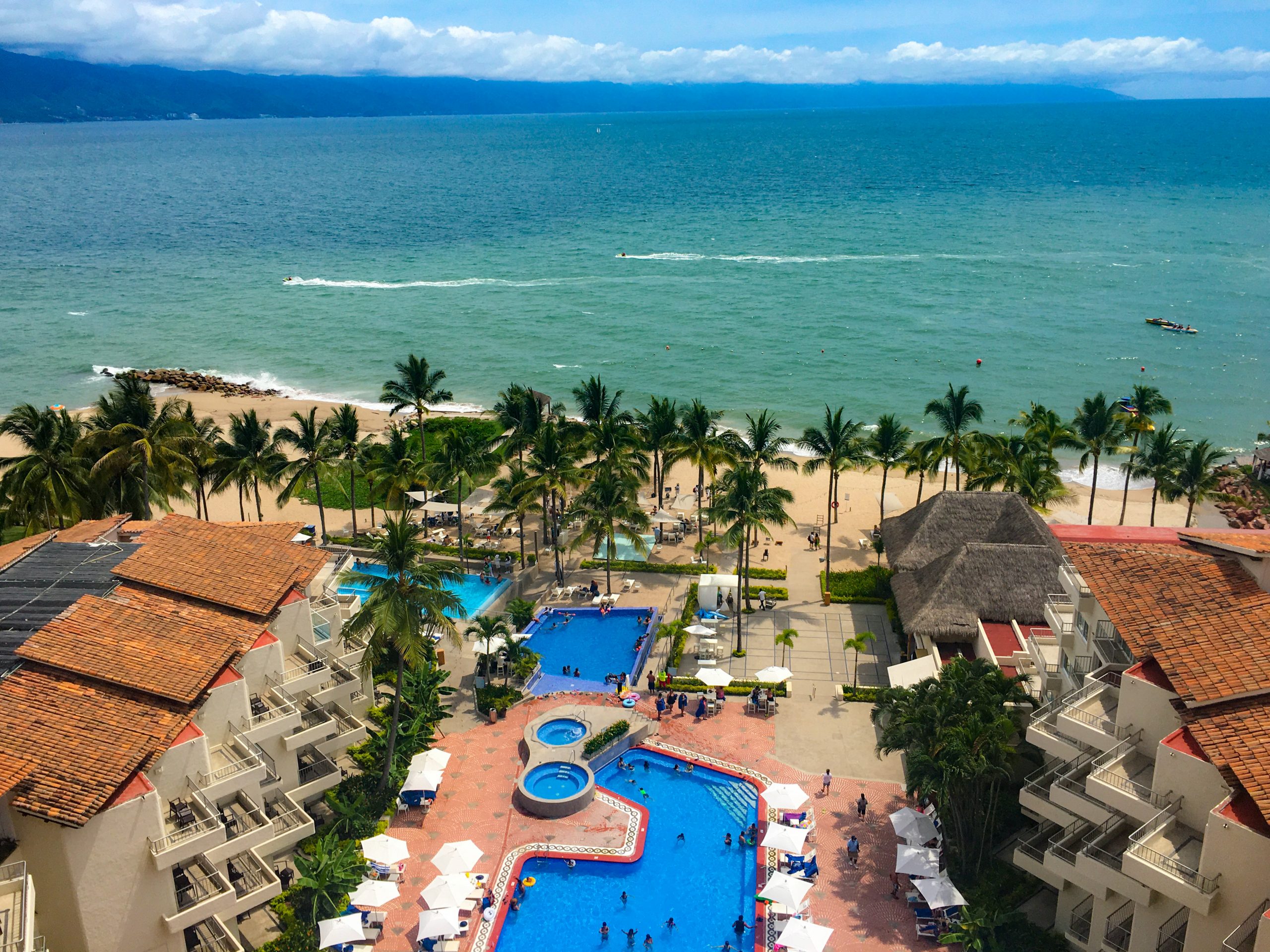 Photo from the 10th floor of the Friendly Vallarta. The pools are in the foreground, with the beach and ocean in the background.